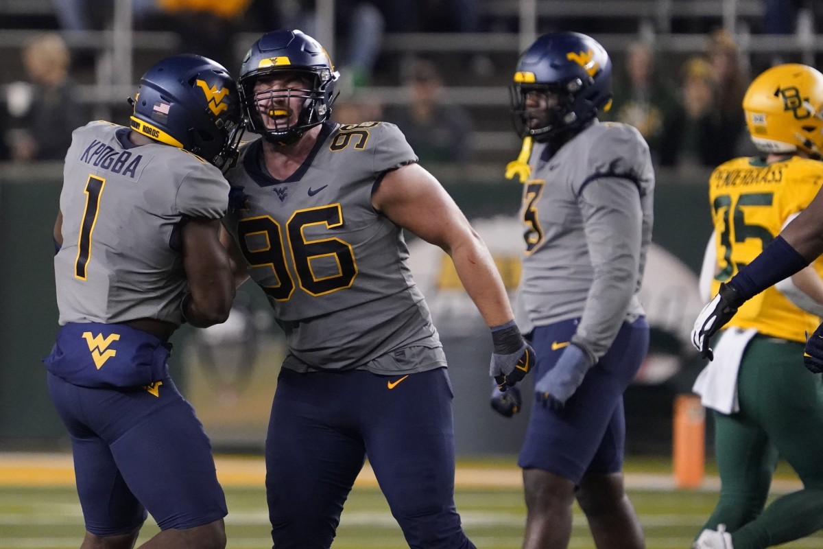 Nov 25, 2023; Waco, Texas, USA; West Virginia Mountaineers defensive lineman Edward Vesterinen (96) reacts with linebacker Lee Kpogba (1) after a sack against the Baylor Bears during the second half at McLane Stadium.