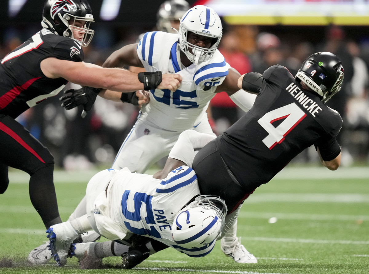 Dec 24, 2023; Atlanta, Georgia, USA; Indianapolis Colts defensive end Kwity Paye (51) works to bring down Atlanta Falcons quarterback Taylor Heinicke (4) during a game at Mercedes-Benz Stadium.