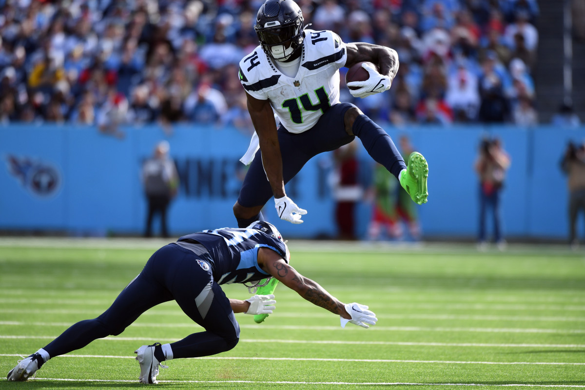 DK Metcalf hurdles a Titans defender