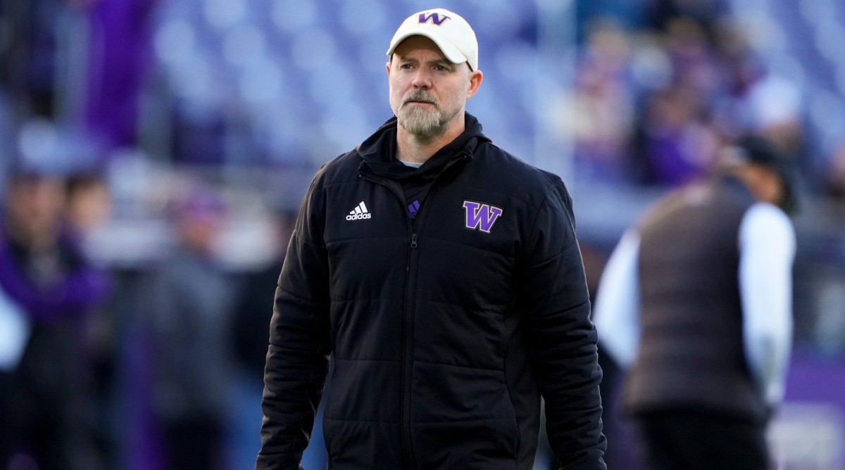 Washington offensive coordinator Ryan Grubb walks on the field before a game against Washington State.