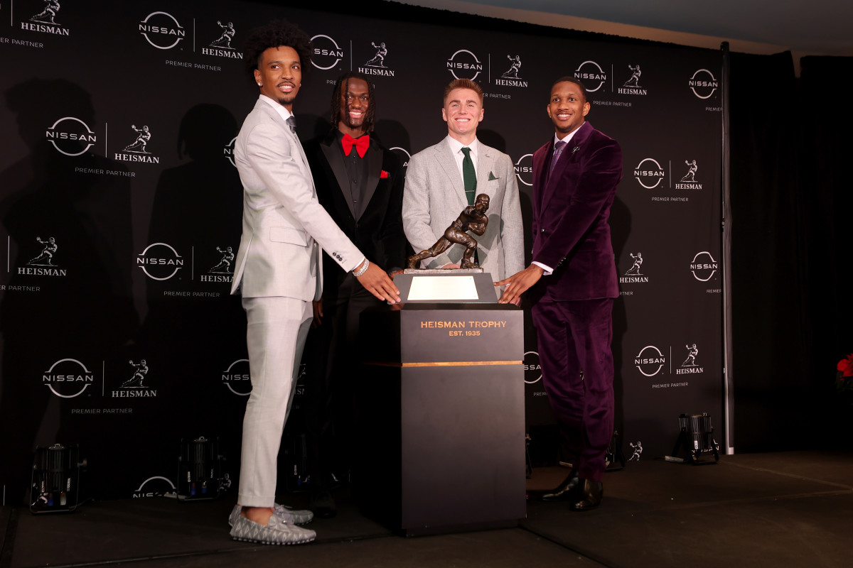 Dec 9, 2023; New York, New York, USA; Heisman hopefuls (left to right) LSU Tigers quarterback Jayden Daniels and Ohio State Buckeyes wide receiver Marvin Harrison Jr. and Oregon Ducks quarterback Bo Nix and Washington Huskies quarterback Michael Penix Jr. pose with the Heisman trophy during a press conference in the Astor ballroom at the New York Marriott Marquis before the presentation of the Heisman trophy. Mandatory Credit: Brad Penner-USA TODAY Sports