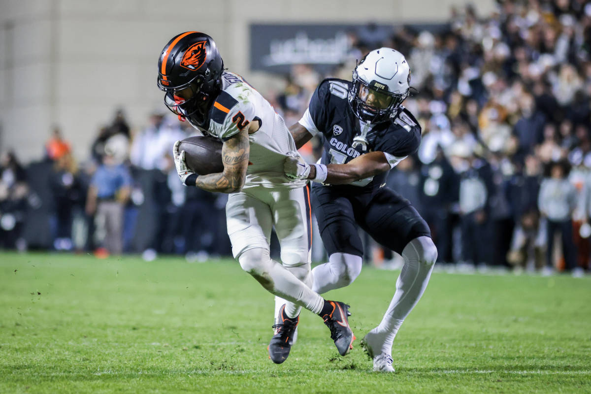 Oregon State Beavers wide receiver Anthony Gould (2) is tackled by Colorado Buffaloes cornerback Kyndrich Breedlove (10) at Folsom Field