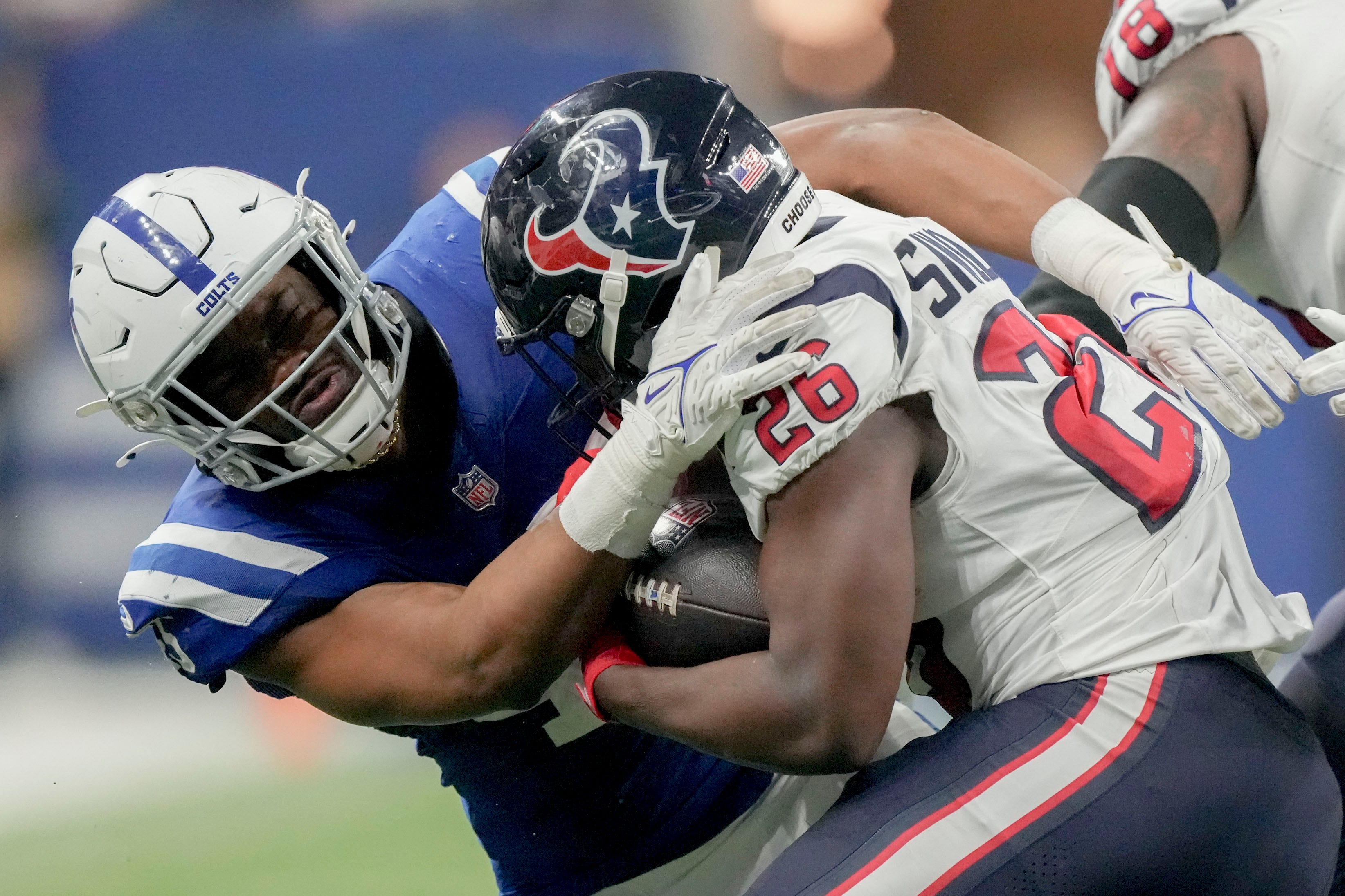 Indianapolis Colts linebacker E.J. Speed (45) works to bring down Houston Texans running back Devin Singletary (26) on Saturday, Jan. 6, 2024, during a game against the Houston Texans at Lucas Oil Stadium in Indianapolis.  