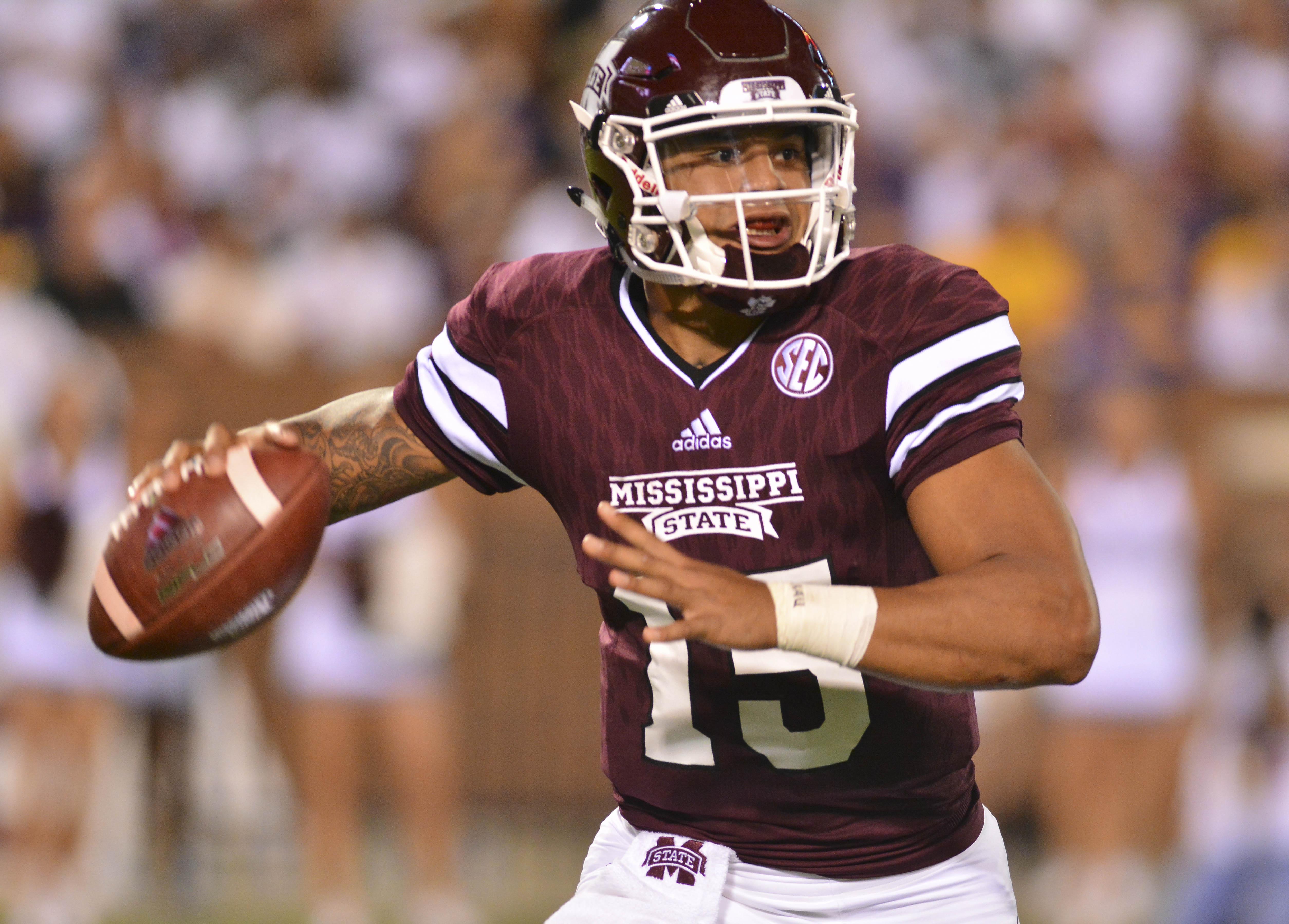 Mississippi State Bulldogs quarterback Dak Prescott (15) drops back to pass during the 2nd quarter of the game against the LSU Tigers at Davis Wade Stadium. 