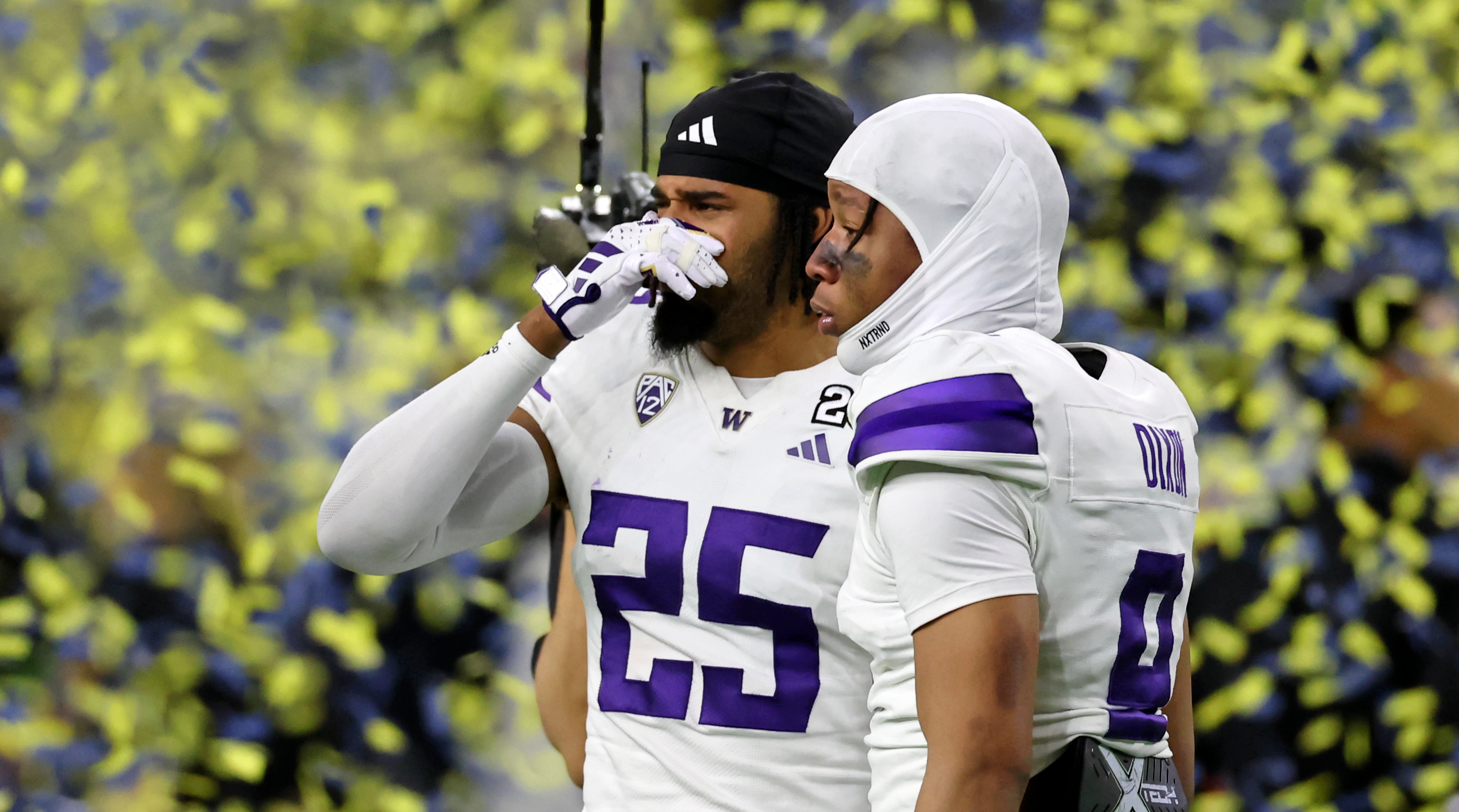 Washington cornerback Elijah Jackson (left) holds back tears while cornerback Thaddeus Dixon looks on after losing to Michigan in the 2024 College Football Playoff national championship game.