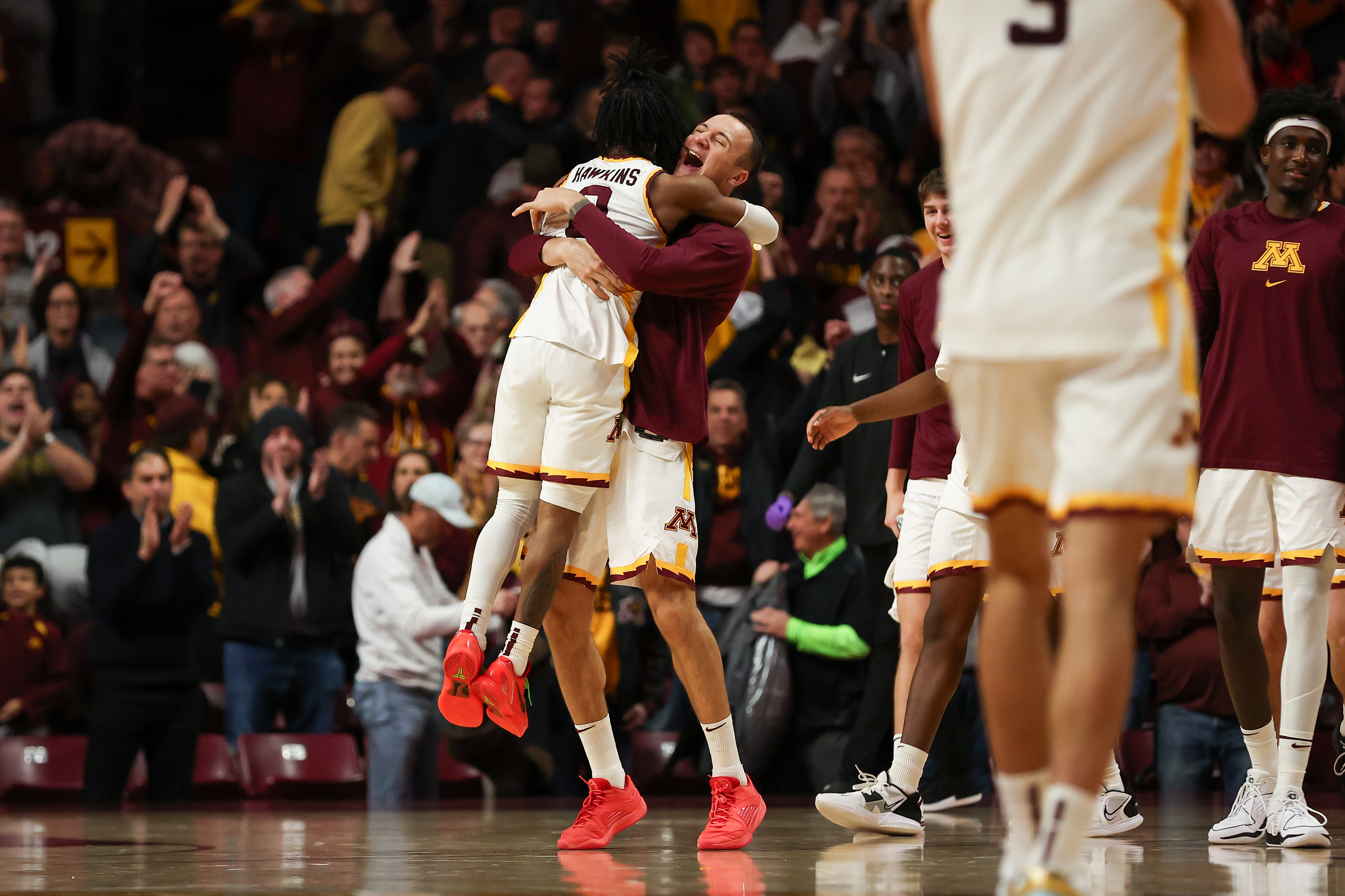 Elijah Hawkins and Kris Keinys embrace