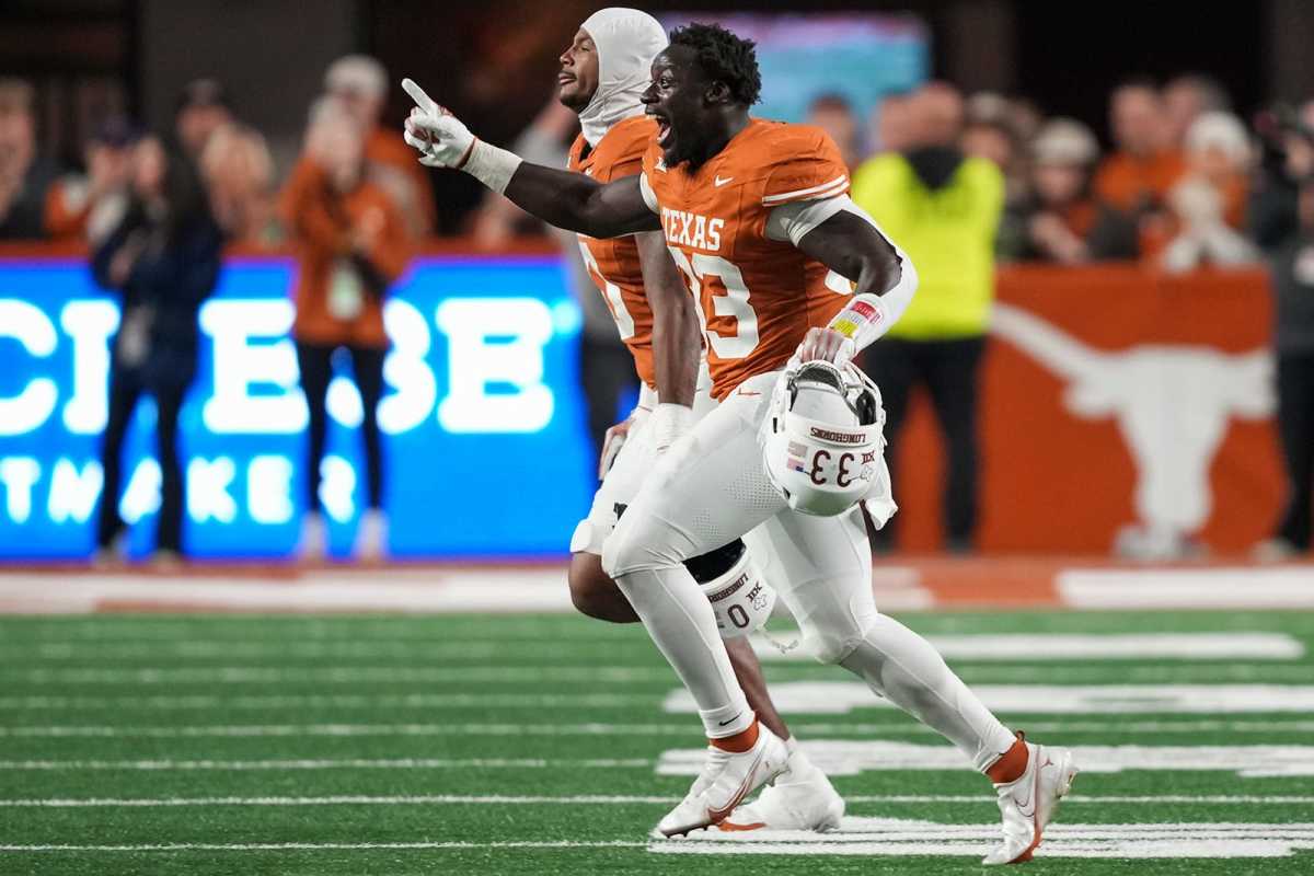 Texas Longhorns linebacker David Gbenda (33) runs onto the field in celebration after winning the game against Texas Tech at Darrell K Royal Texas Memorial Stadium on Friday, Nov. 24, 2023.