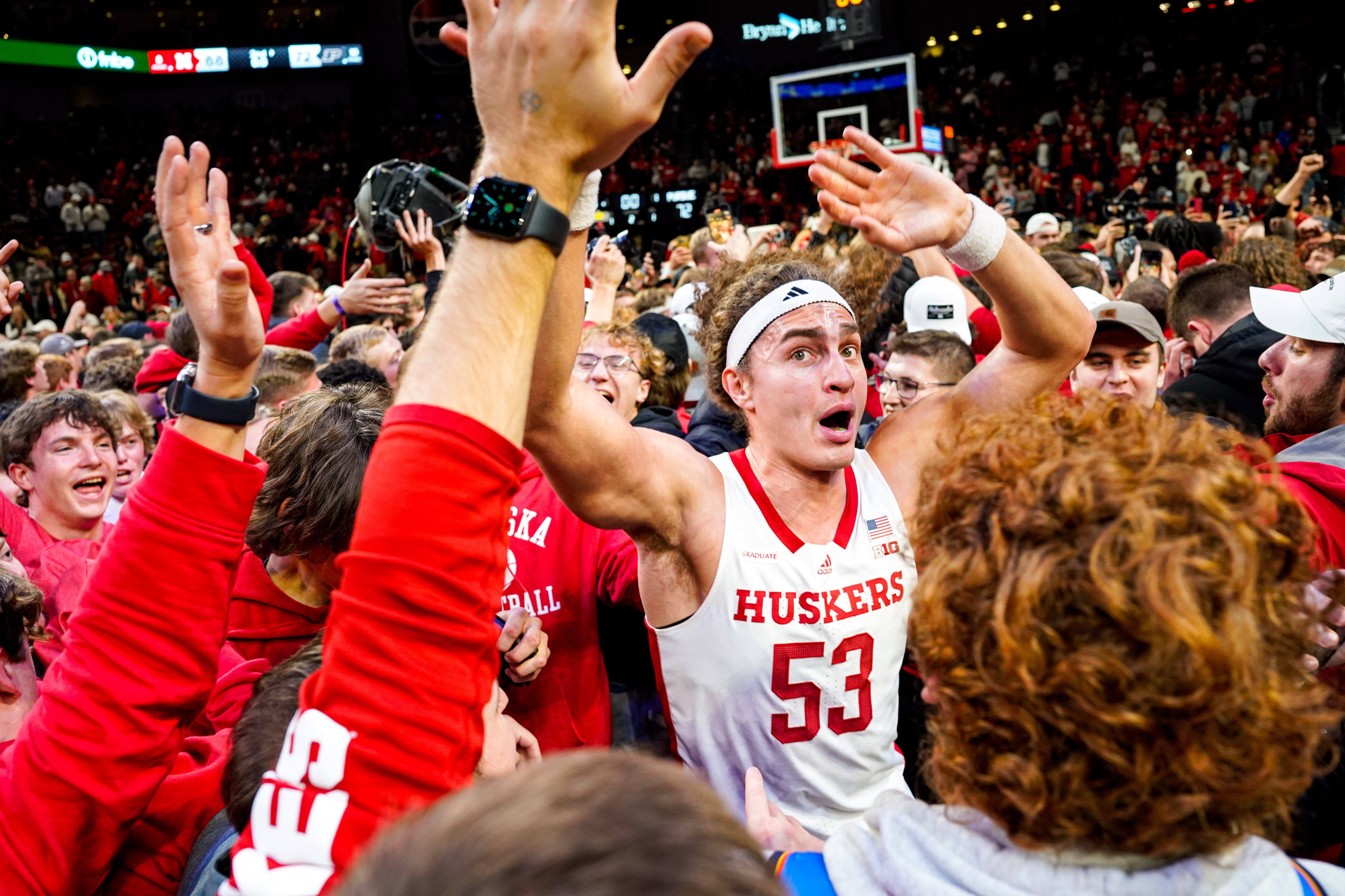 Nebraska forward Josiah Allick celebrates with fans who stormed the court after the Huskers' 88-72 win Tuesday night over top-ranked Purdue at Pinnacle Bank Arena in Lincoln.  (Jan 9, 2024)