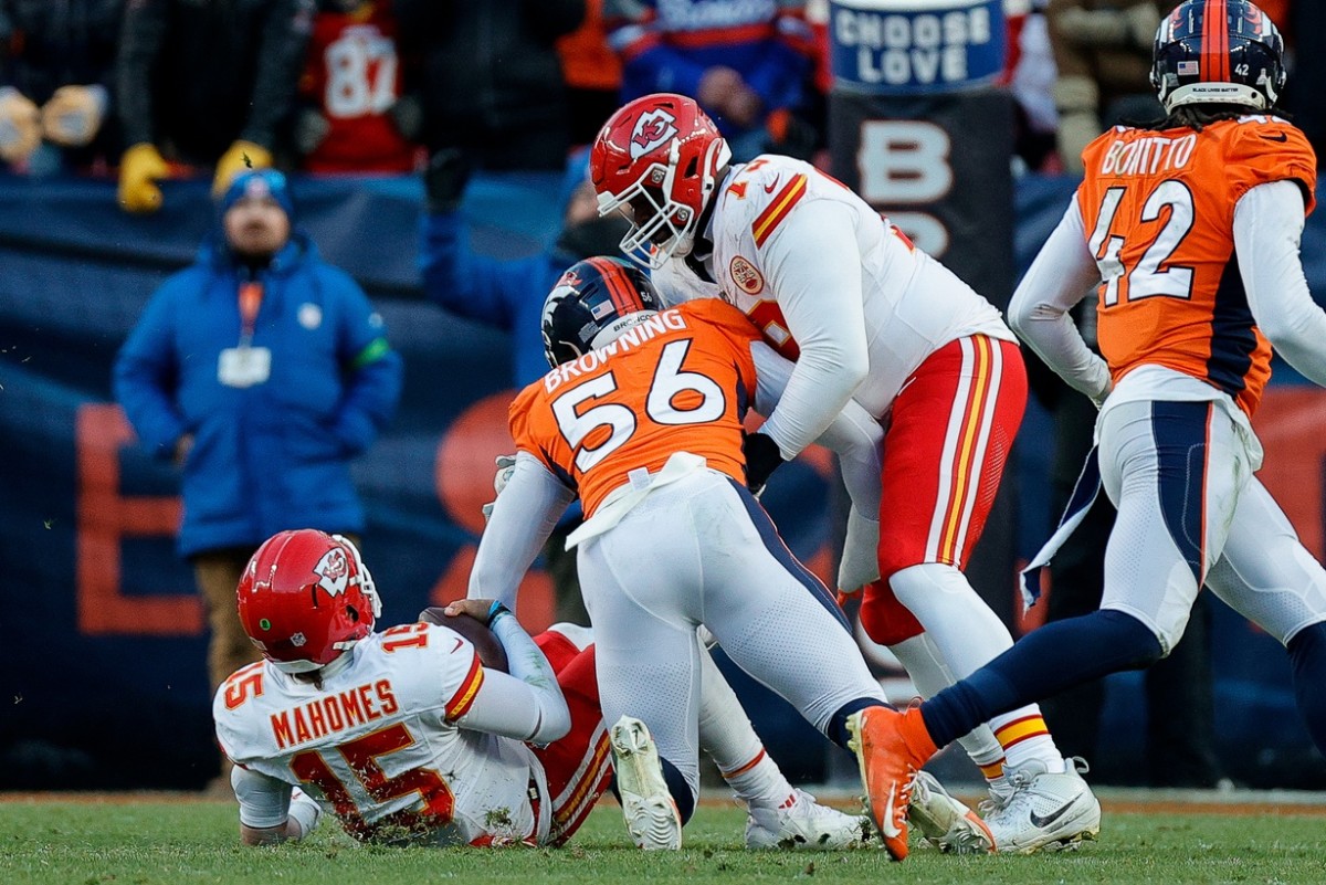 Oct 29, 2023; Denver, Colorado, USA; Kansas City Chiefs quarterback Patrick Mahomes (15) falls to the ground after colliding with offensive tackle Donovan Smith (79) as Denver Broncos linebacker Baron Browning (56) defends in the fourth quarter at Empower Field at Mile High. Mandatory Credit: Isaiah J. Downing-USA TODAY Sports  