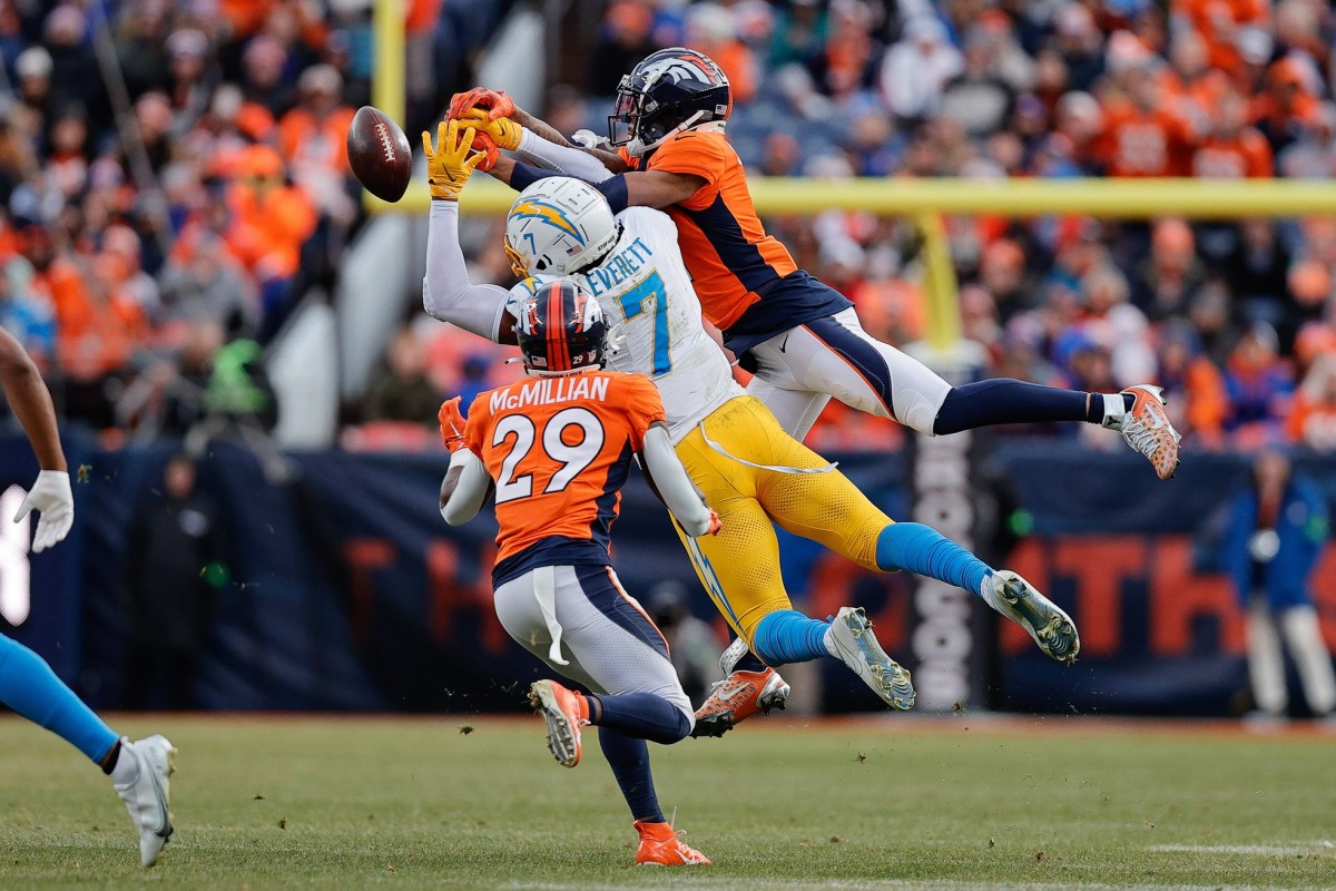 Dec 31, 2023; Denver, Colorado, USA; Denver Broncos cornerback Pat Surtain II (2) and Los Angeles Chargers tight end Gerald Everett (7) attempt to grab a pass as cornerback Ja'Quan McMillian (29) defends in the second quarter at Empower Field at Mile High. Mandatory Credit: Isaiah J. Downing-USA TODAY Sports  