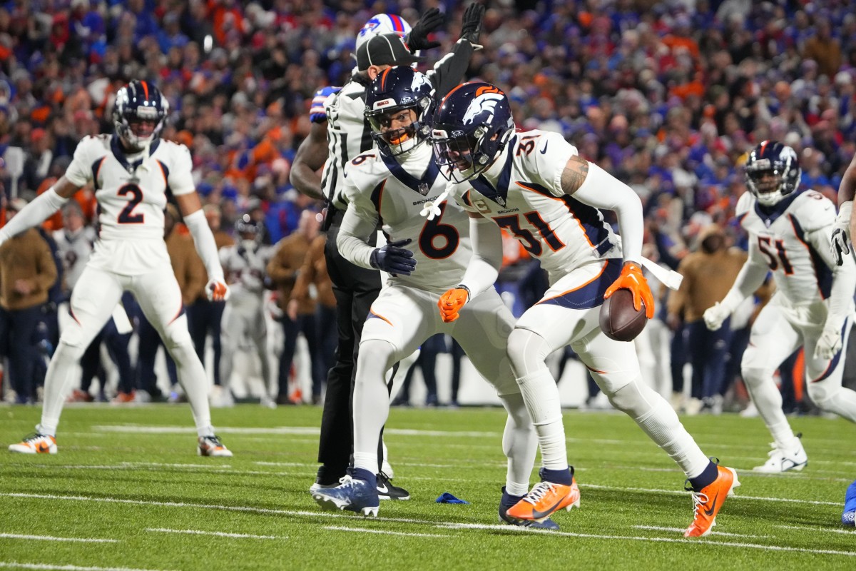 Nov 13, 2023; Orchard Park, New York, USA; Denver Broncos safety Justin Simmons (31) reacts after intercepting a pass with safety P.J. Locke (6) against the Buffalo Bills during the first half at Highmark Stadium. Mandatory Credit: Gregory Fisher-USA TODAY Sports  