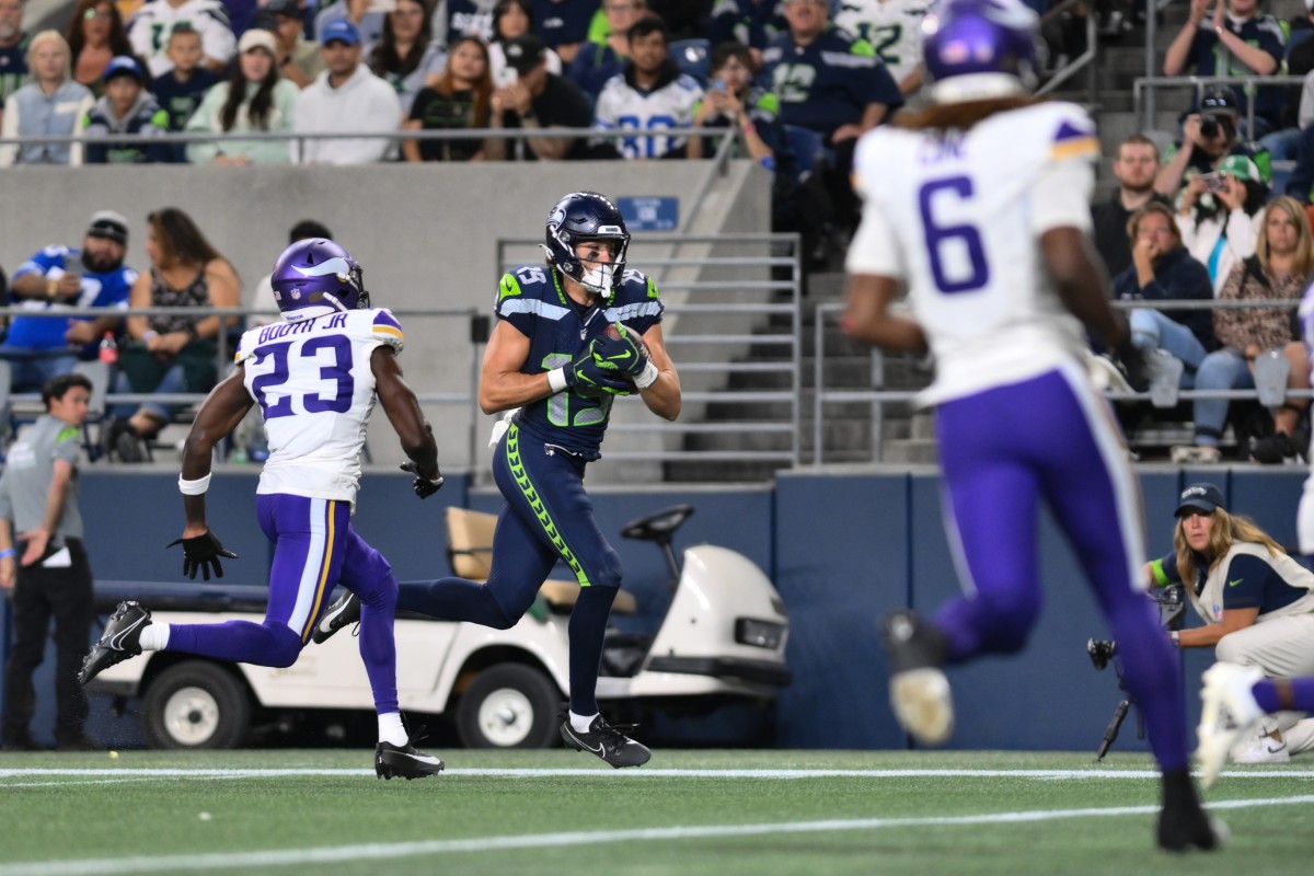 Aug 10, 2023; Seattle, Washington, USA; Seattle Seahawks wide receiver Jake Bobo (19) runs the ball in for a touchdown past Minnesota Vikings cornerback Andrew Booth Jr. (23) during the second half at Lumen Field.