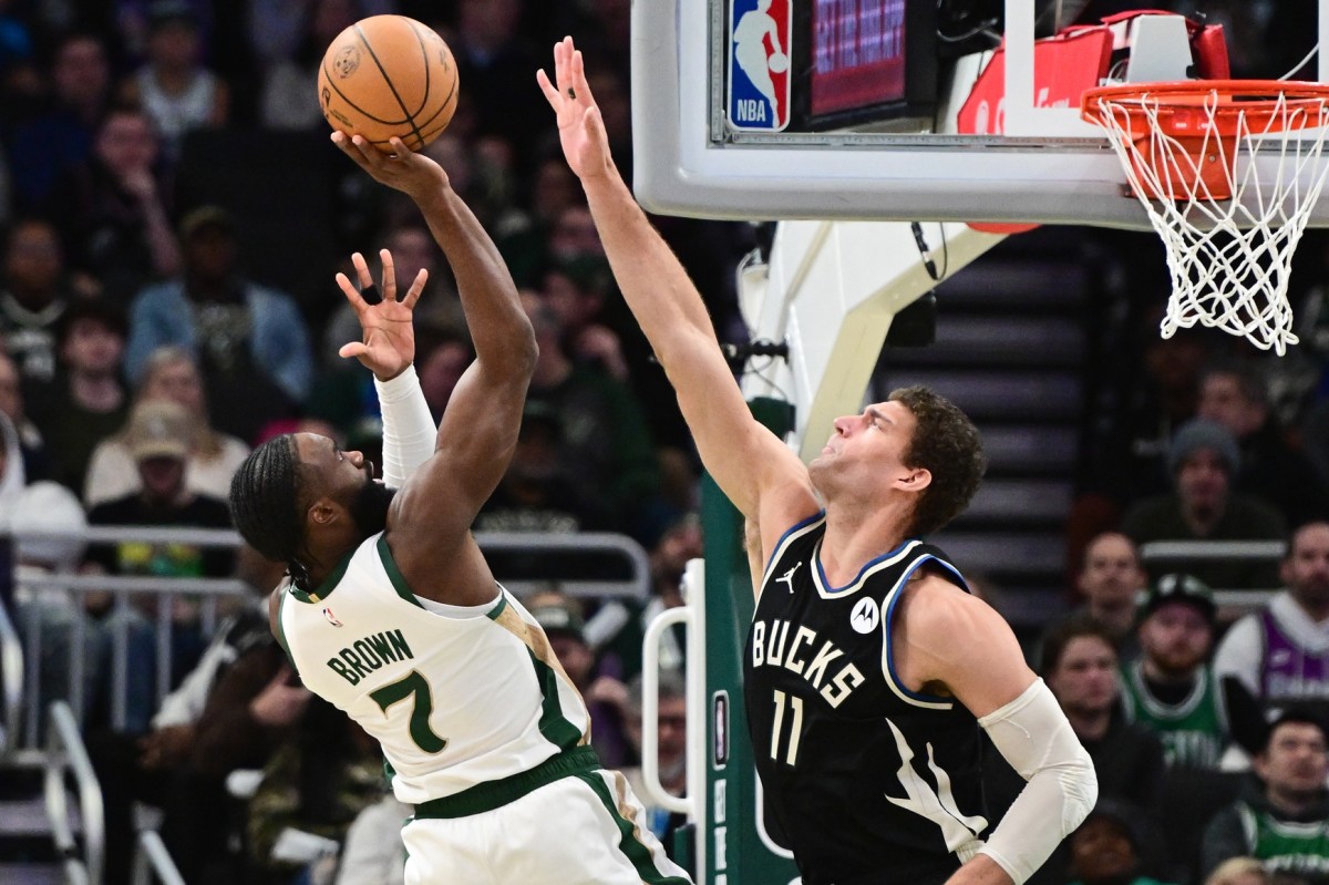 Boston Celtics center Jaylen Brown (7) takes a shot against Milwaukee Bucks center Brook Lopez (11)