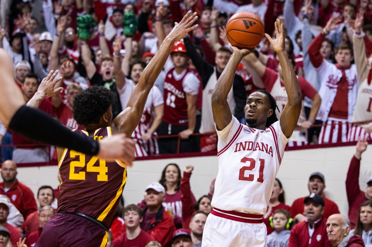 Indiana Hoosiers forward Mackenzie Mgbako (21) shoots the ball while Minnesota Golden Gophers guard Cam Christie (24) defends in the first half at Simon Skjodt Assembly Hall.