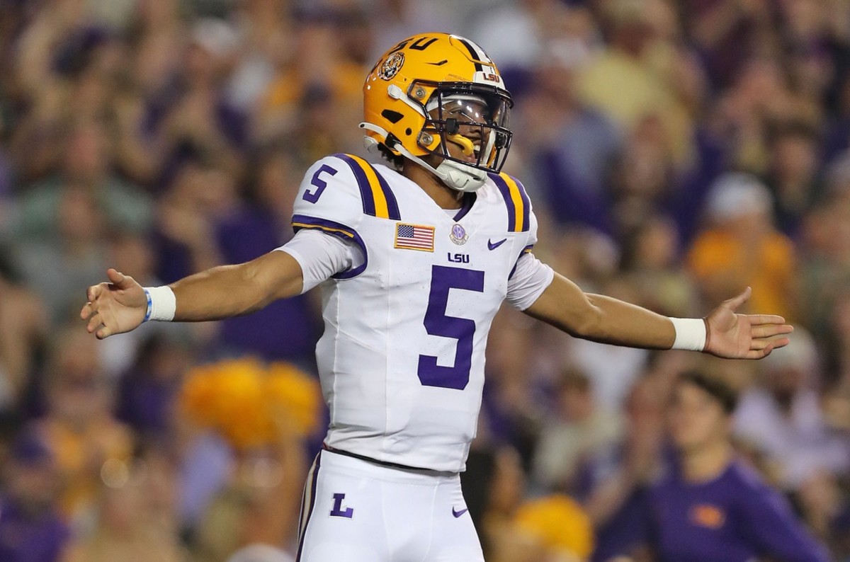 Oct 21, 2023; Baton Rouge, Louisiana, USA; LSU Tigers quarterback Jayden Daniels (5) celebrates a touchdown against the Army Black Knights during the first half at Tiger Stadium. 