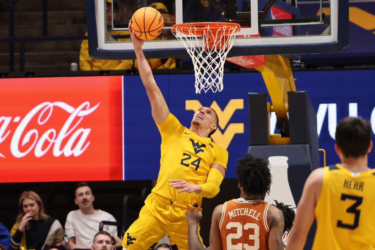 West Virginia forward Pat Suemnick delivers a reverse slam dunk vs. No. 25 Texas.