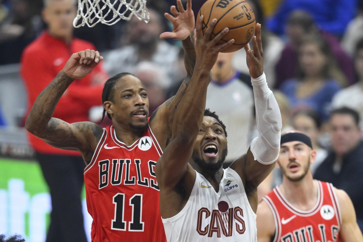 Chicago Bulls forward DeMar DeRozan (11) defends a shot by Cleveland Cavaliers guard Donovan Mitchell (45) in the first quarter at Rocket Mortgage FieldHouse. 