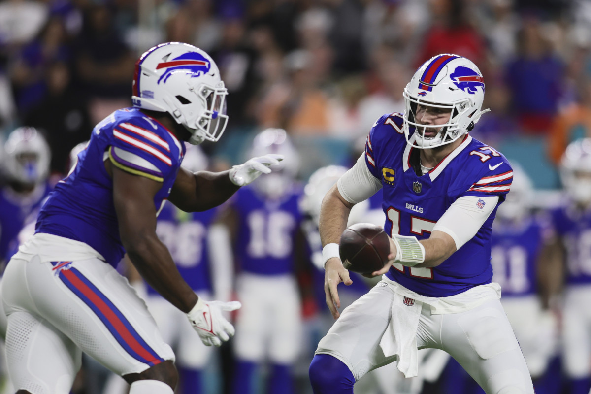 Buffalo Bills quarterback Josh Allen (17) gives the football to running back Leonard Fournette (5) against the Miami Dolphins during the first quarter at Hard Rock Stadium.