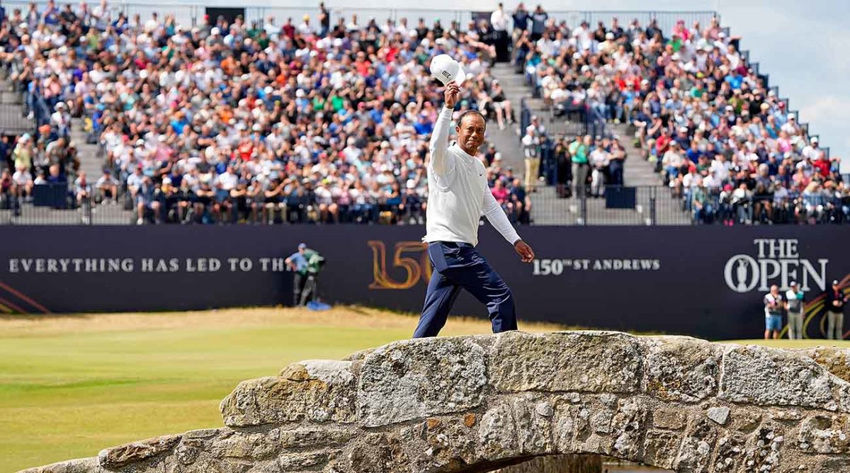 Tiger Woods waves to the crowd while crossing the Swilcan Bridge on the 18th hole at St. Andrews during the second round of the 2022 British Open.