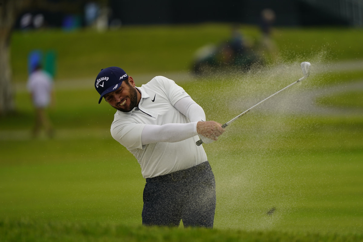 Francesco Molinari fights a fairway bunker