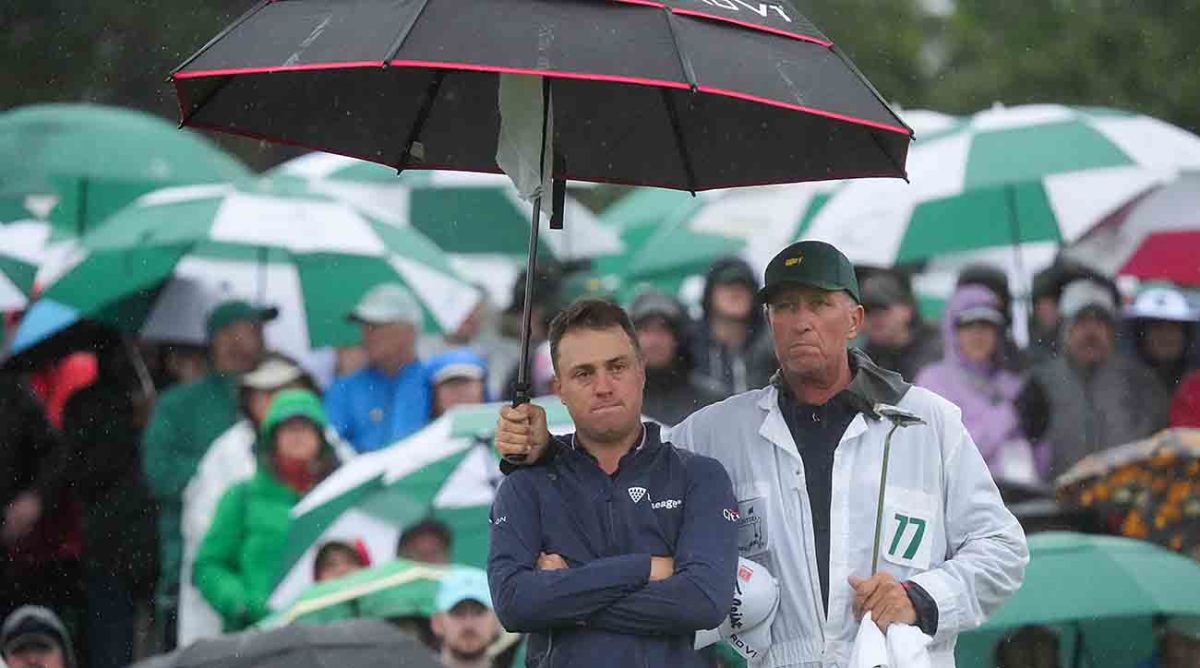 Justin Thomas is pictured with caddie Jim Mackay after missing the cut at the 2023 Masters.