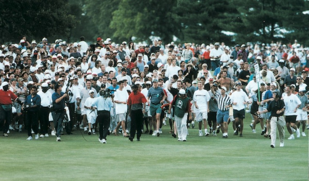 Tiger Woods strolls triumphantly up the 18th fairway at the 1997 Western Open.