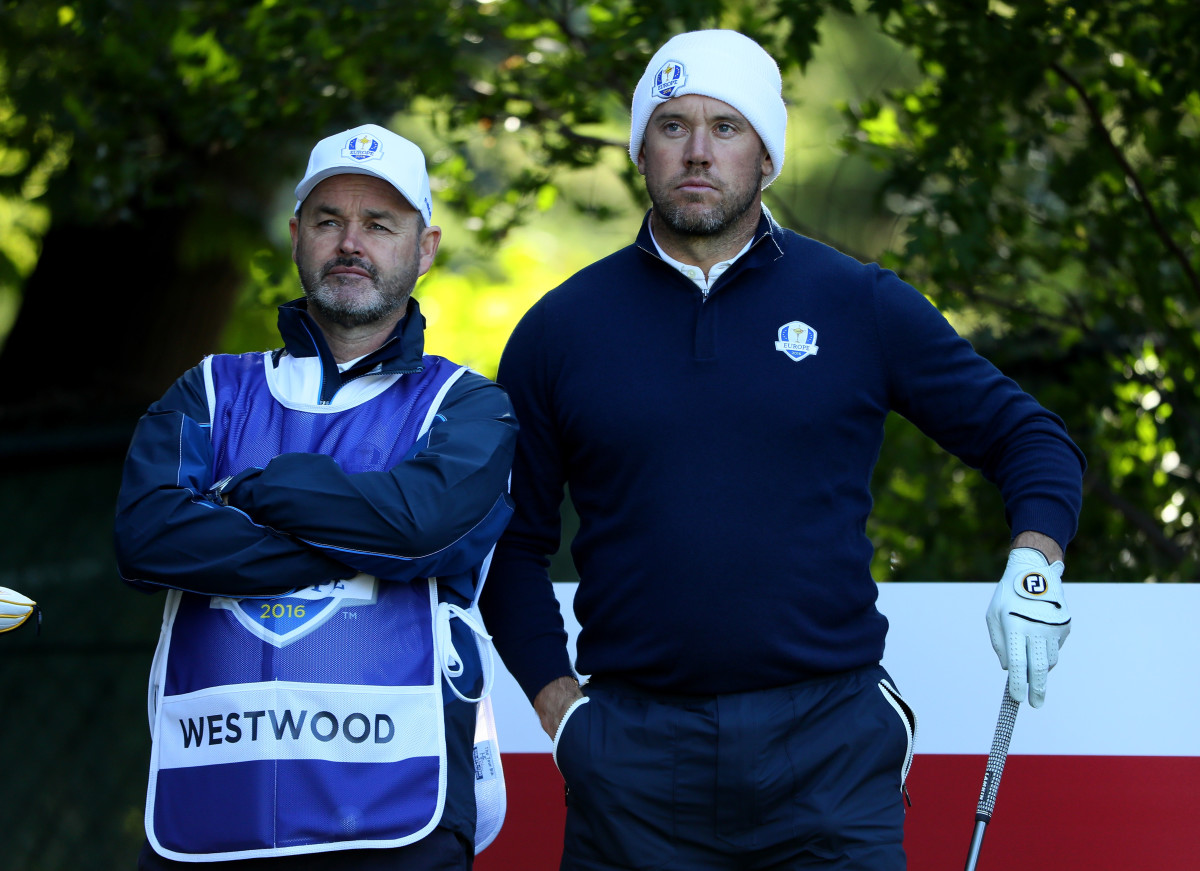 Lee Westwood of Europe (R) looks on from the fifth tee with caddie Billy Foster prior to the 2016 Ryder Cup at Hazeltine National Golf Club on September 27, 2016 in Chaska, Minnesota.