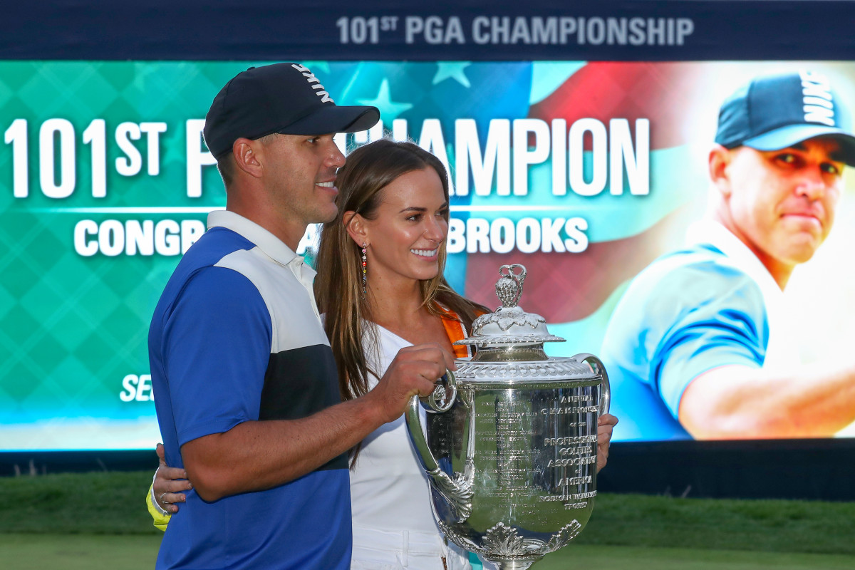 Brooks Koepka of the United States poses with girlfriend Jena Sims and the Wanamaker Trophy during the Trophy Presentation Ceremony after winning the final round of the 2019 PGA Championship at the Bethpage Black course on May 19, 2019 in Farmingdale, New York.