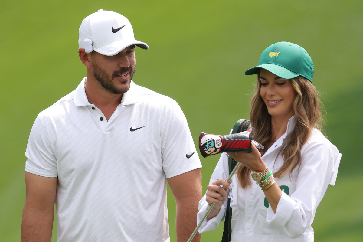 Brooks Koepka of the United States and Jena Sims during the Par Three Contest prior to the Masters at Augusta National Golf Club on April 06, 2022 in Augusta, Georgia.