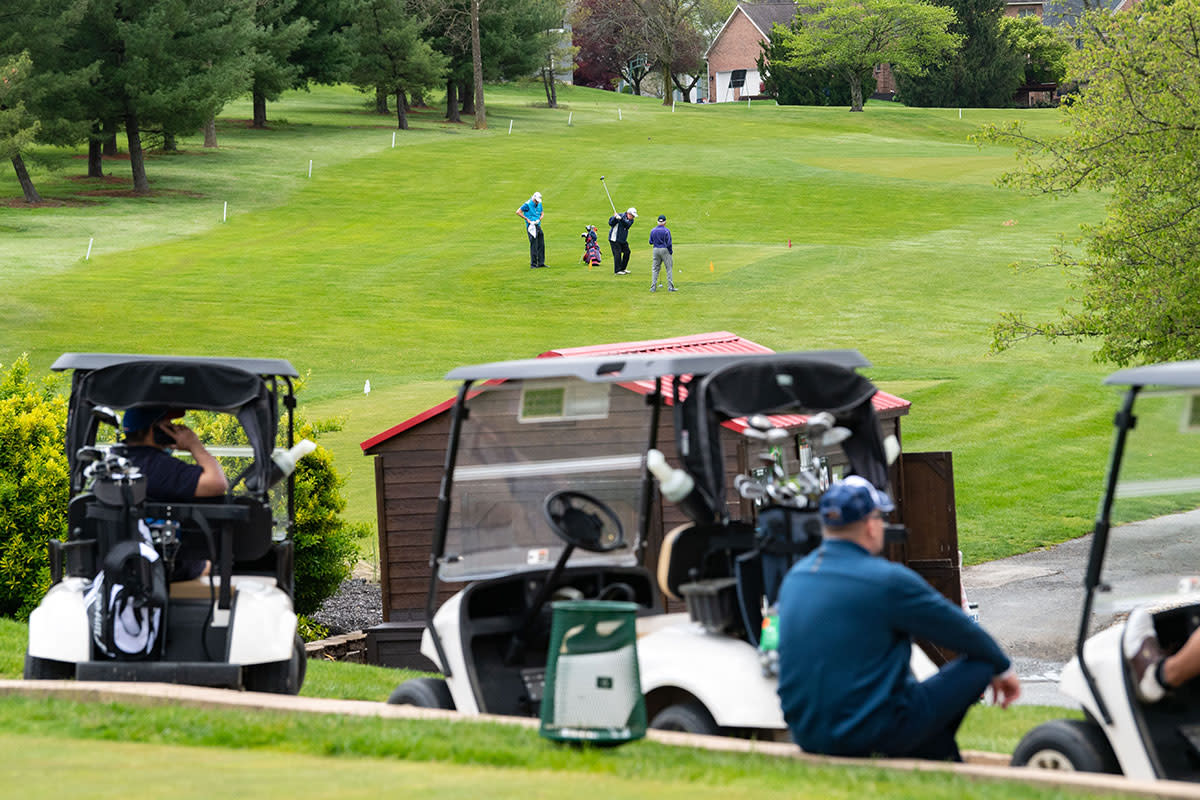 Golfers wait to tee off at a local course.