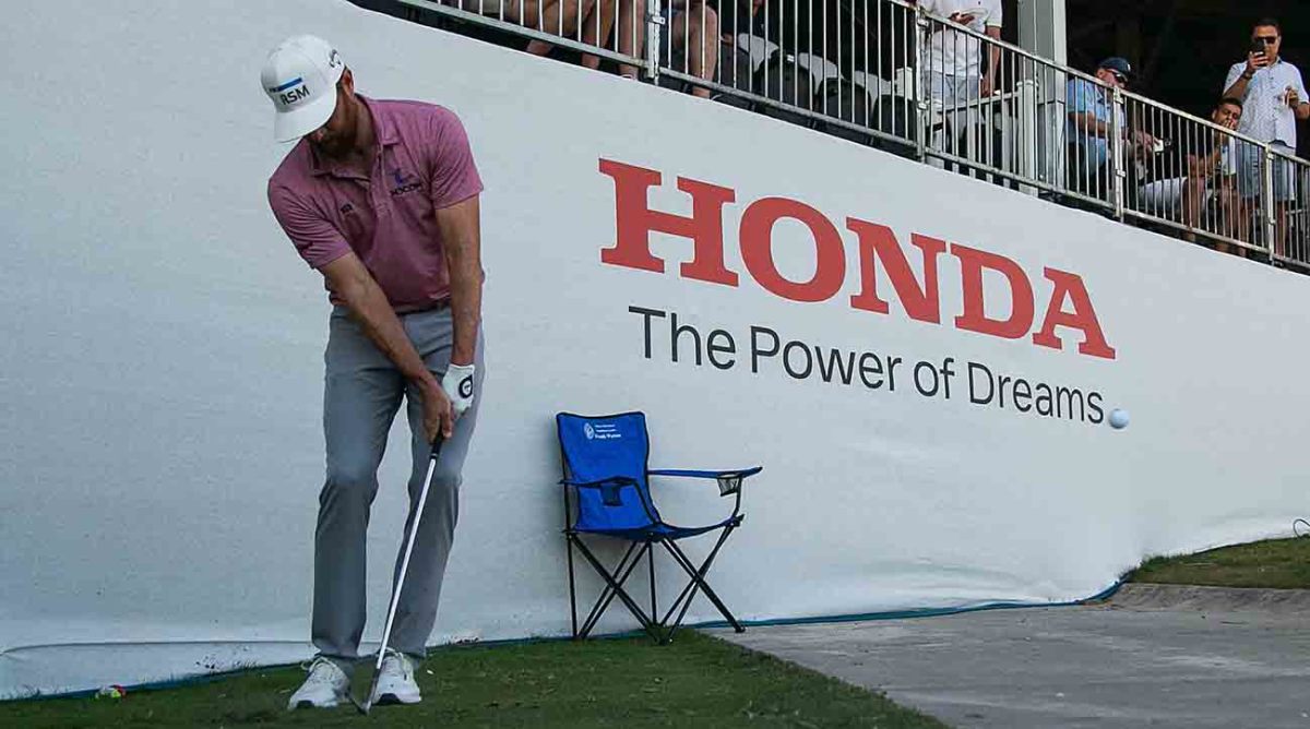 Chris Kirk chips near a grandstand at the 2023 Honda Classic.