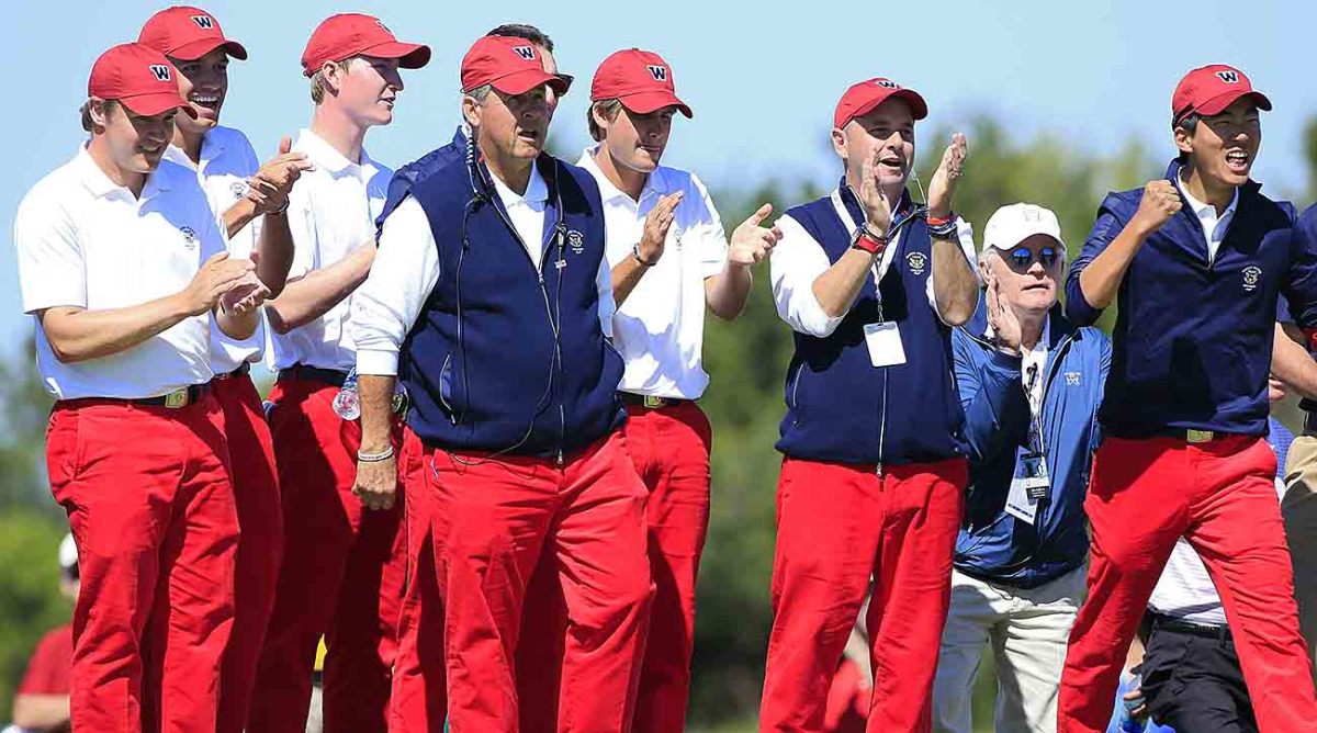 Captain Jim Holtgrieve and members of the U.S. team react on the 17th green as the U.S. wins the last foursomes match during the morning foursome matches on Day 1 of the 2013 Walker Cup at National Golf Links of America.