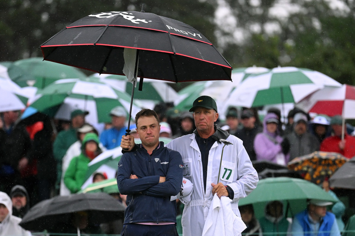 Justin Thomas of the United States and his caddie Jim 'Bones' Mackay react to his bogey on the 18th green during the continuation of the weather delayed second round of the 2023 Masters Tournament at Augusta National Golf Club on April 08, 2023 in Augusta, Georgia.