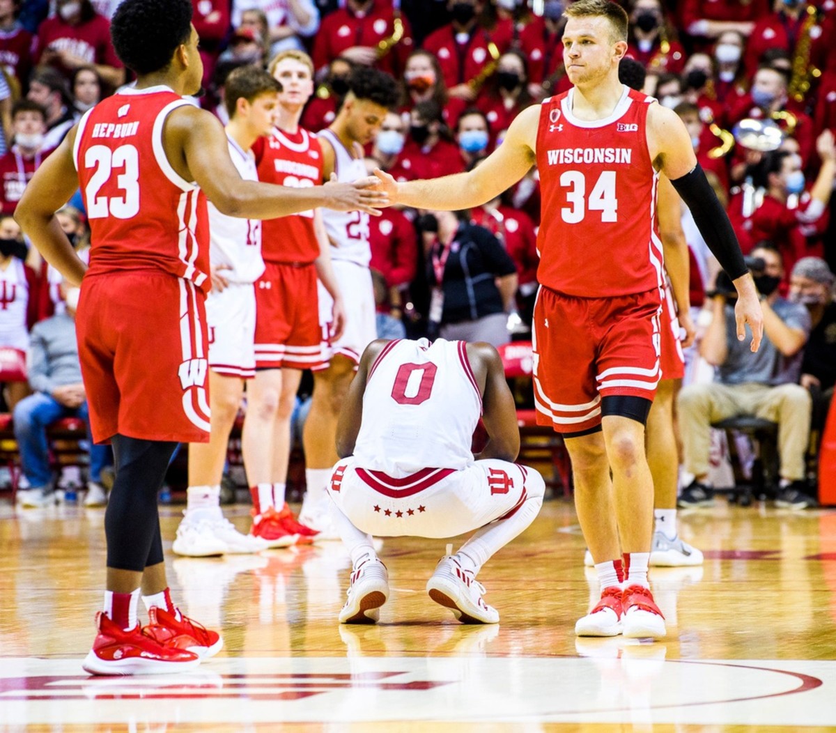 Indiana's Xavier Johnson (0) hangs his head as Wisconsin's Brad Davison (34) and Chucky Hepburn begin to celebrate a Big Ten victory in Bloomington in 2022.