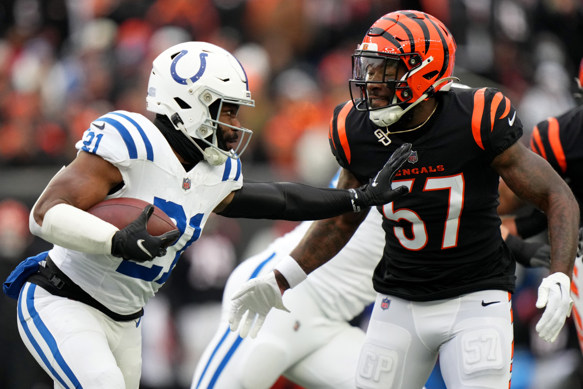 Dec. 10, 2023; Cincinnat, Ohio, USA; Indianapolis Colts running back Zack Moss (21) carries the ball as Cincinnati Bengals linebacker Germaine Pratt (57) defends in the first quarterat Paycor Stadium.