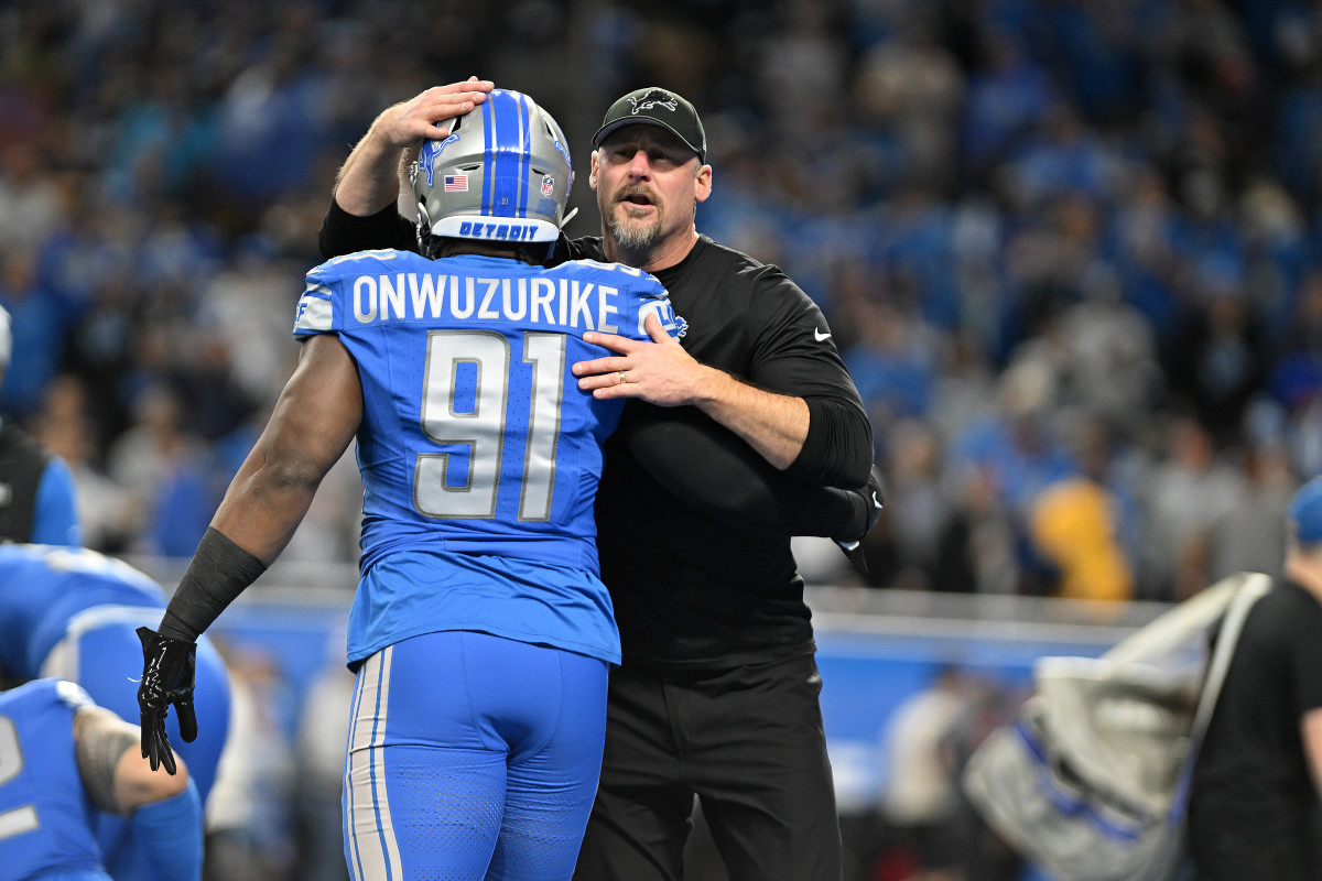 Dan Campbell hugs Levi Onwuzurike, patting him on the head