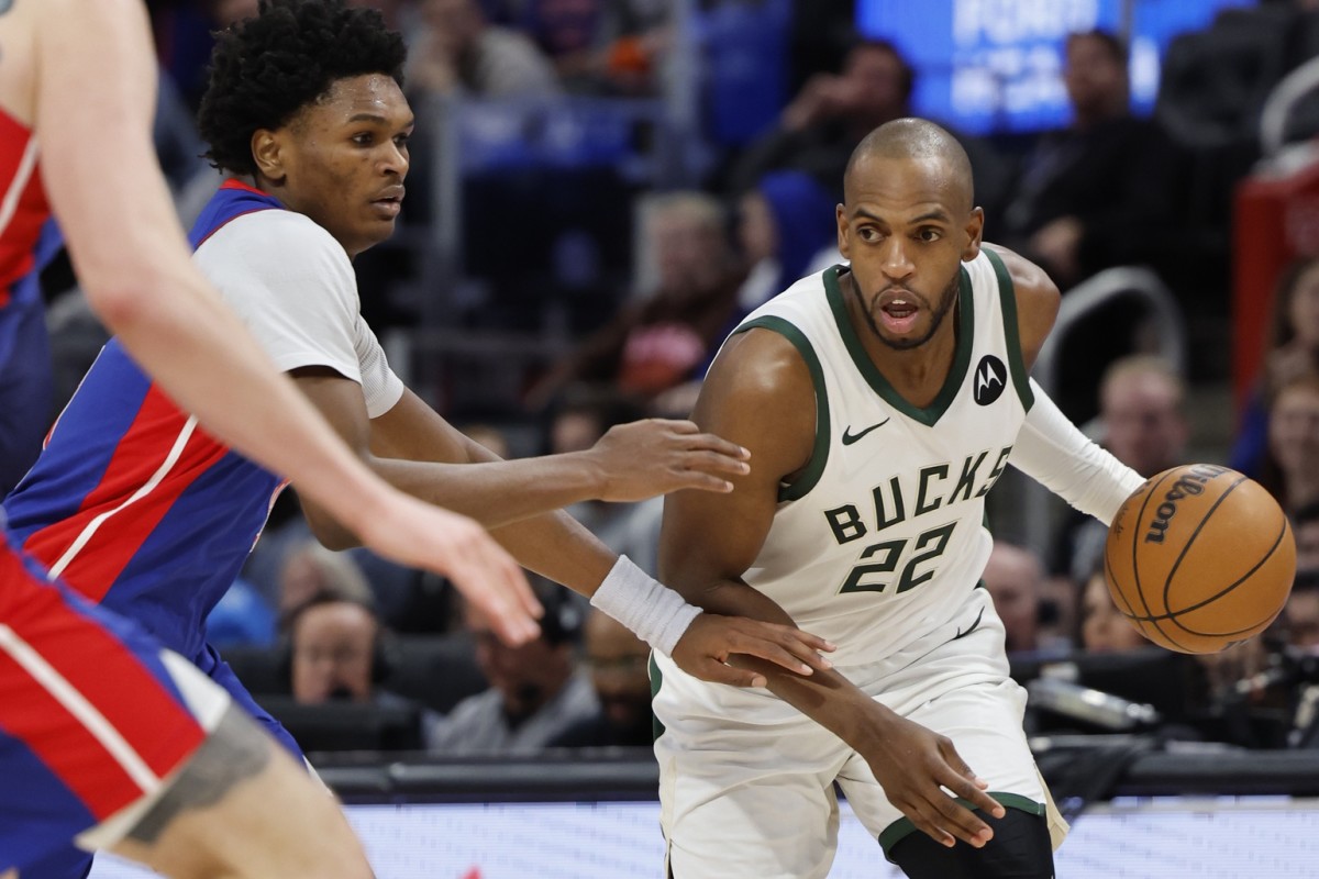  Milwaukee Bucks forward Khris Middleton (22) dribbles defended by Detroit Pistons forward Ausar Thompson (9) in the second half at Little Caesars Arena.