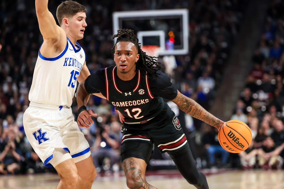 Jan 23, 2024; Columbia, South Carolina, USA; South Carolina Gamecocks guard Zachary Davis (12) drives around Kentucky Wildcats guard Reed Sheppard (15) in the first half at Colonial Life Arena. Mandatory Credit: Jeff Blake-USA TODAY Sports