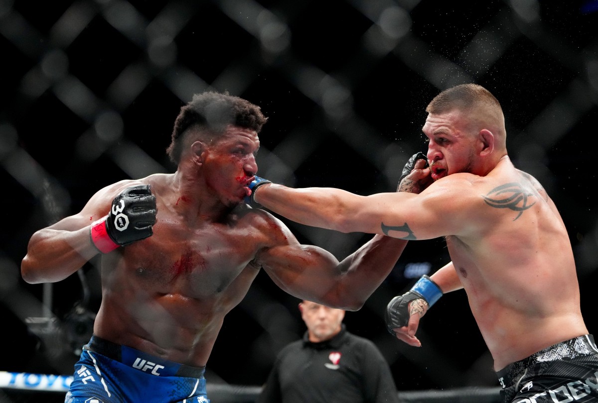 Alonzo Menifield (red gloves) fights Dustin Jacoby (blue gloves) during UFC 296 