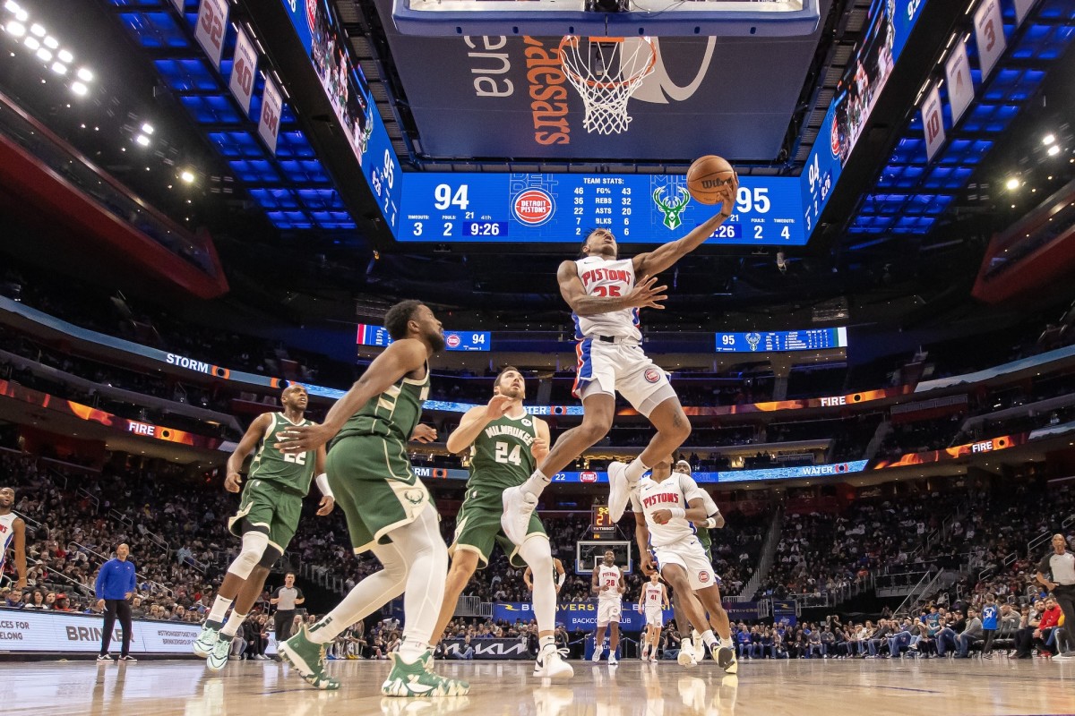 Detroit Pistons guard Marcus Sasser drives to the basket in front of Milwaukee Bucks forward Khris Middleton, guard Malik Beasley and guard Pat Connaughton.