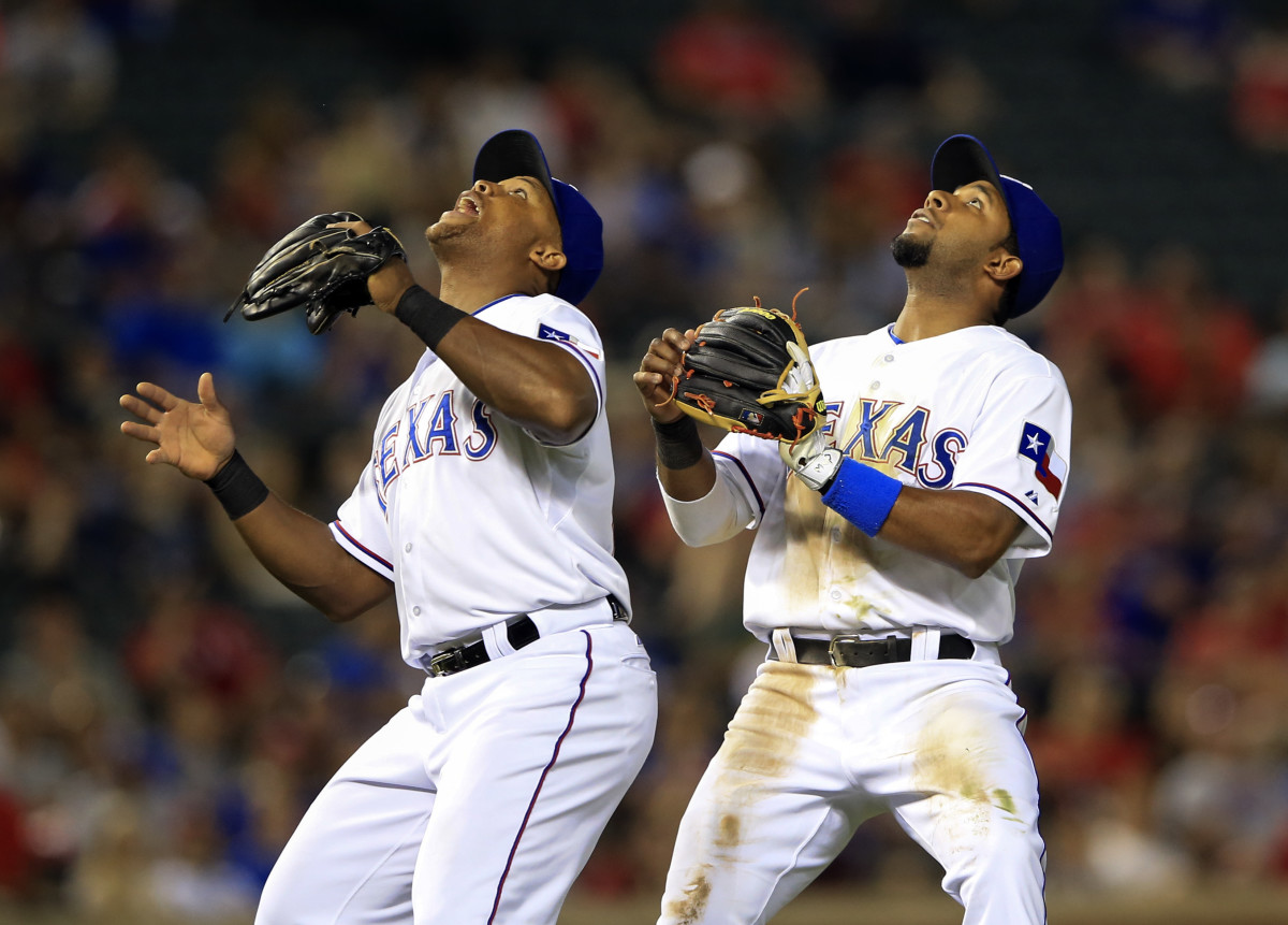 Texas Rangers third baseman Adrian Beltre left, and shortstop Elvis Andrus prepare for a fly ball during a game against the Oakland Athletics in May 2015 at Globe Life Park in Arlington.