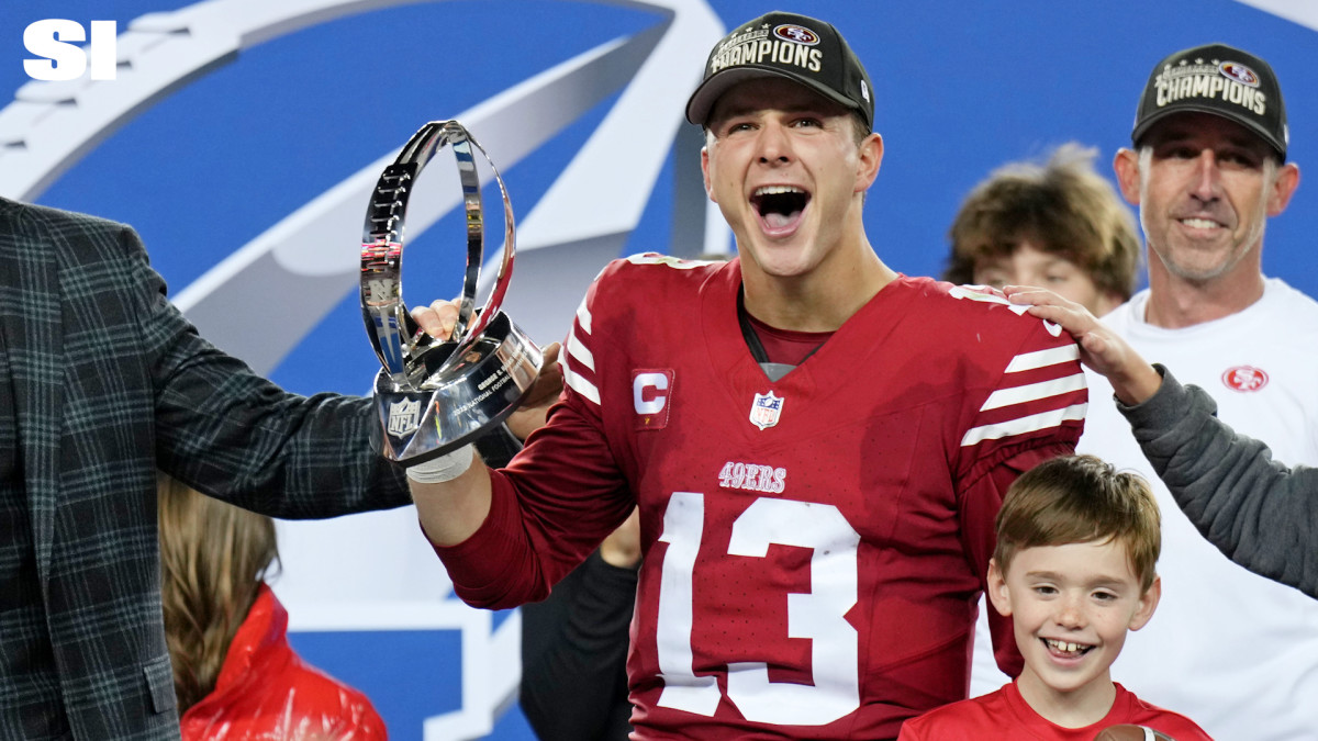 Brock Purdy holds the NFC Championship trophy after the 49ers beat the Detroit Lions.