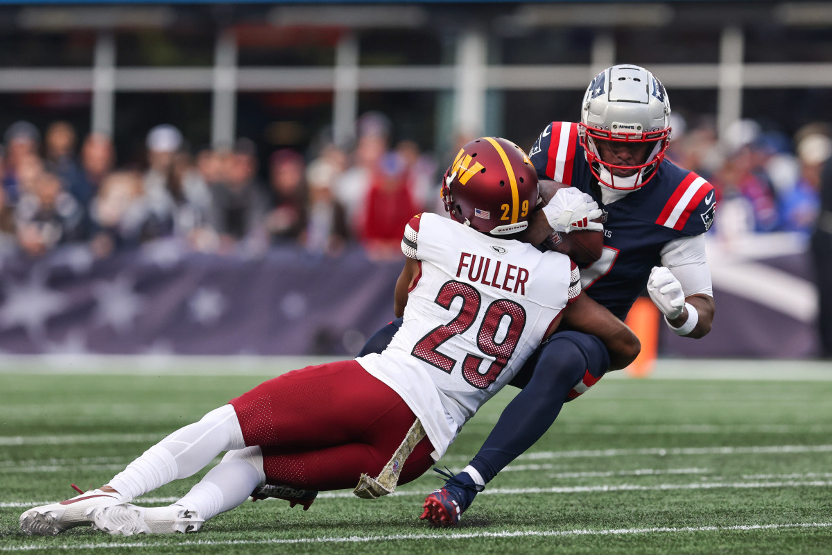 Nov 5, 2023; Foxborough, Massachusetts, USA; Washington Commanders cornerback Kendall Fuller (29) tackles New England Patriots receiver JuJu Smith-Schuster (7) during the second half at Gillette Stadium.