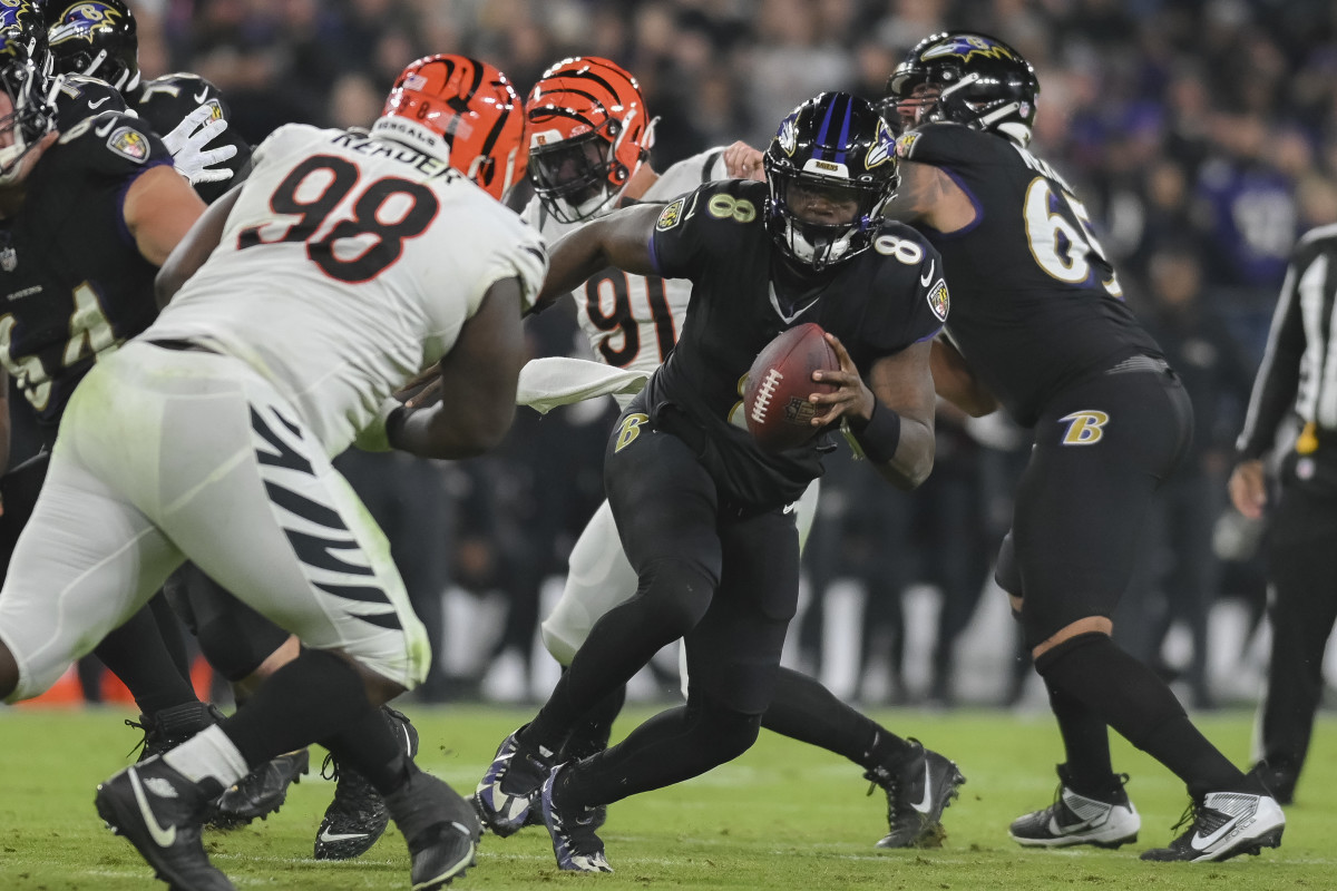 Nov 16, 2023; Baltimore, Maryland, USA; Baltimore Ravens quarterback Lamar Jackson (8) runs as Cincinnati Bengals defensive tackle DJ Reader (98) defends during the game at M&T Bank Stadium.