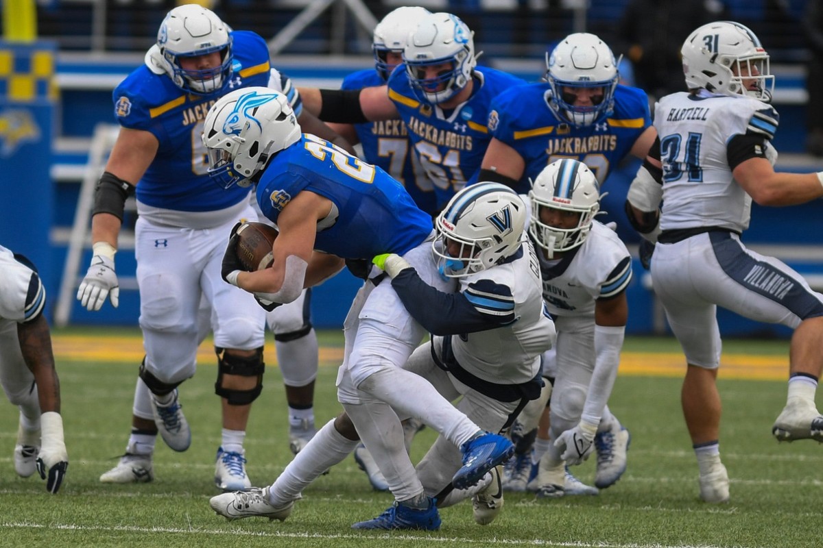 SDSU's running back Isaiah Davis (22) gets tackled by a Villanova player on Saturday, Dec. 9, 2023 at Dana J. Dykhouse in Brookings.