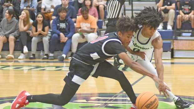 Windermere's Ta'Veon Jones (0) goes for a steal against Edgewater's Tanares Jefferson during the third quarter of Windermere's 83-75 victory. Jones tallied game-highs in points (26) and rebounds (11), while Jefferson had a team-high 21 points.