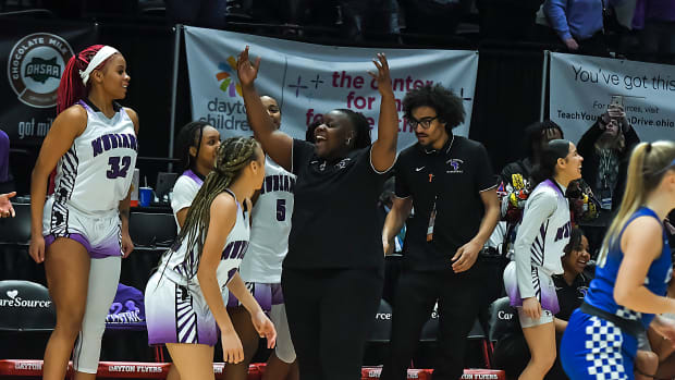 Africentric girls basketball coach Janicia Anderson and her players start to celebrate as time ticks down in the 2023 OHSAA Division III state championship game. Africentric defeated Chippewa 75-62 to claim the state title.