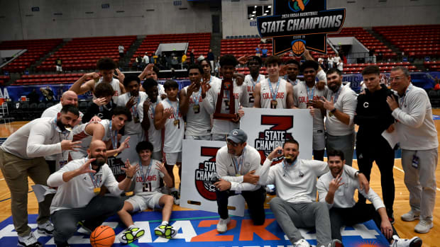 Miami Columbus players and coaches gather together after three-peating as the FHSAA Class 7A state champions on Saturday at the RP Funding Center in Lakeland.