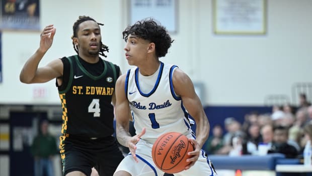 Quinn Barnett of Brunswick looks to make a pass around a defender in a district final win over St. Edward on March 9, 2024.