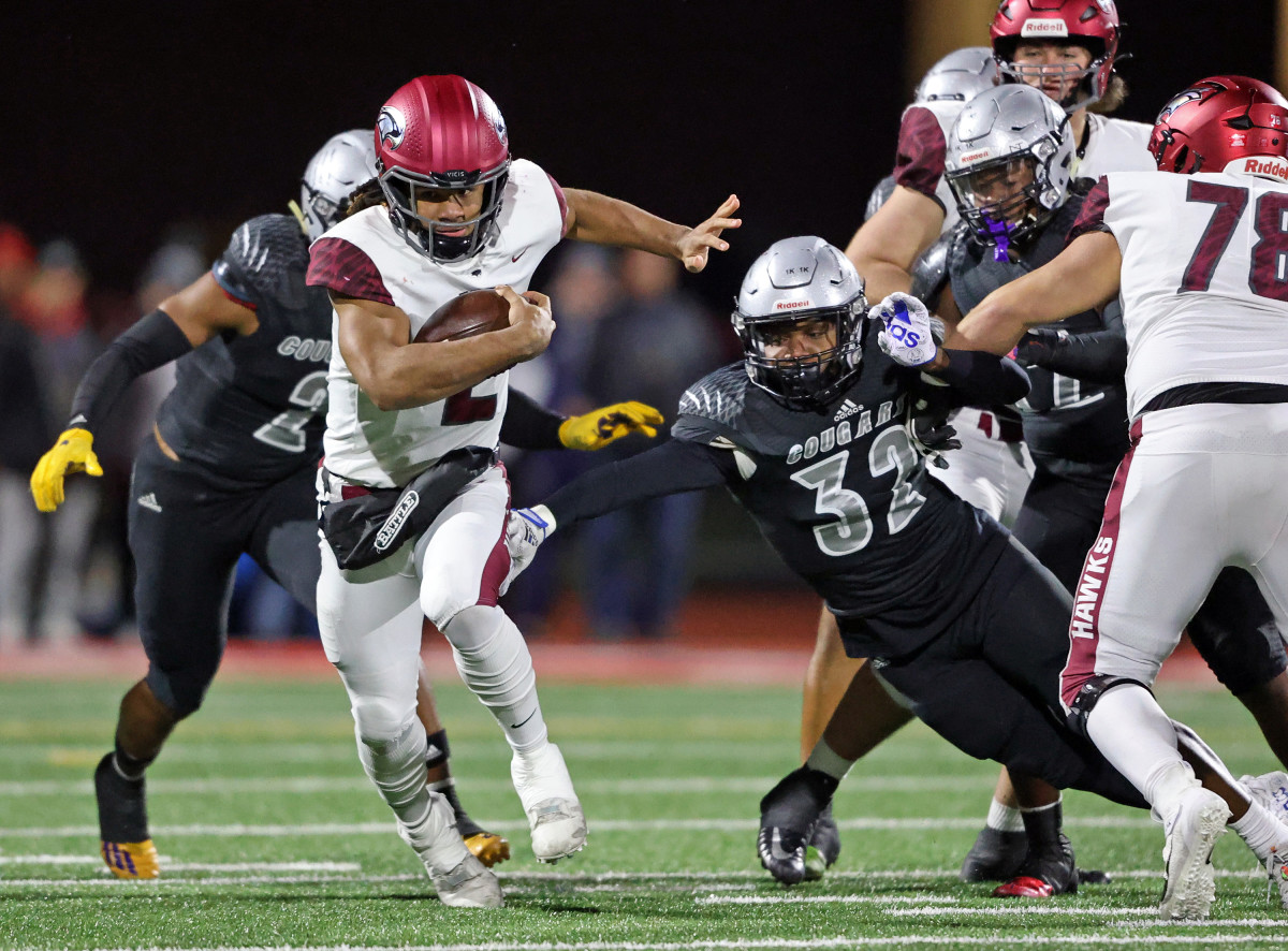 St. Joseph's Prep quarterback Samaj Jones escapes defenders in the 2022 PIAA Class 6A state championship game. (Photo: Paul Burdick, SBLive Sports)